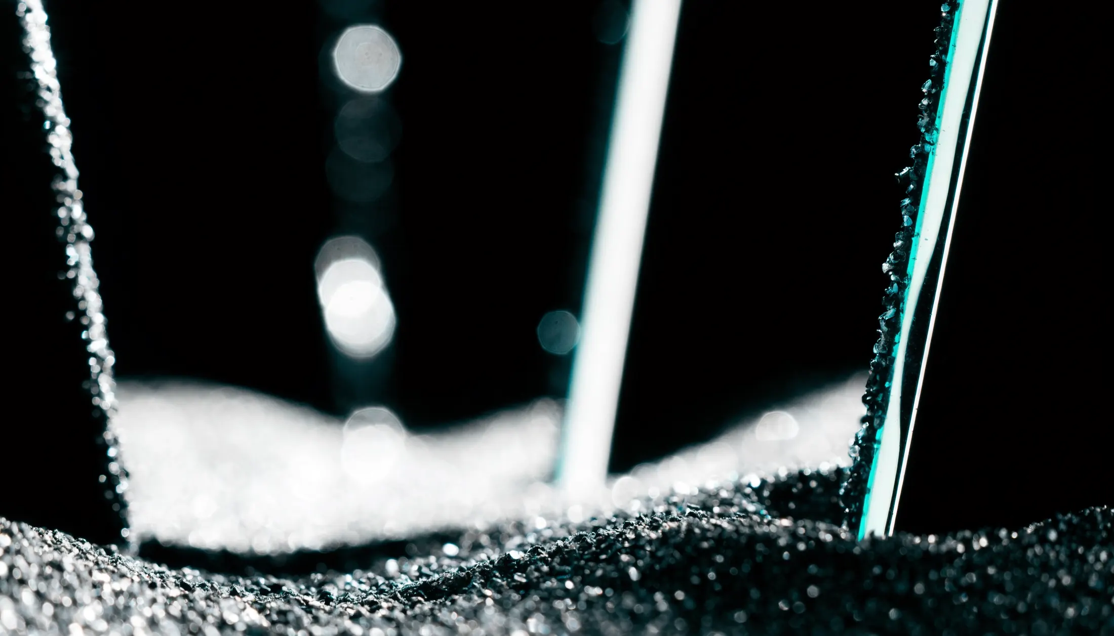Glass-layer defense surface with black sand particulate detail